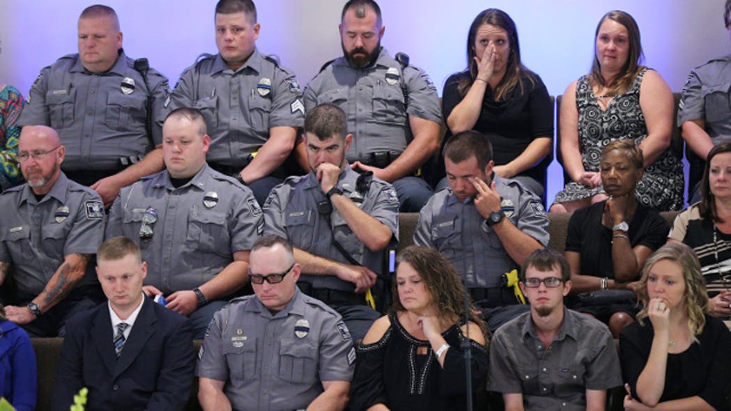 Members of the Polk County Police Department become emotional sitting in the choir loft during the funeral of fellow Polk County police detective Kristen Hearne on Tuesday, Oct. 3, 2017,