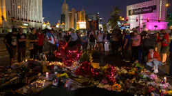 A crowd gathers Wednesday, Oct. 4, 2017 to pay tribute at a memorial for the victims of the mass shooting near the crime scene off Las Vegas Boulevard in Las Vegas, Nev.
