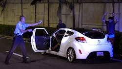 Puerto Rico Police Officer Heriberto Soto shouts commands to the passengers and driver after a late-night high speed chase through San Juan on Wednesday, Oct. 18, 2017. Puerto Rico Police Officer Heriberto Soto shouts commands to the passengers and driver after a late-night high speed chase through San Juan on Wednesday, Oct. 18, 2017.