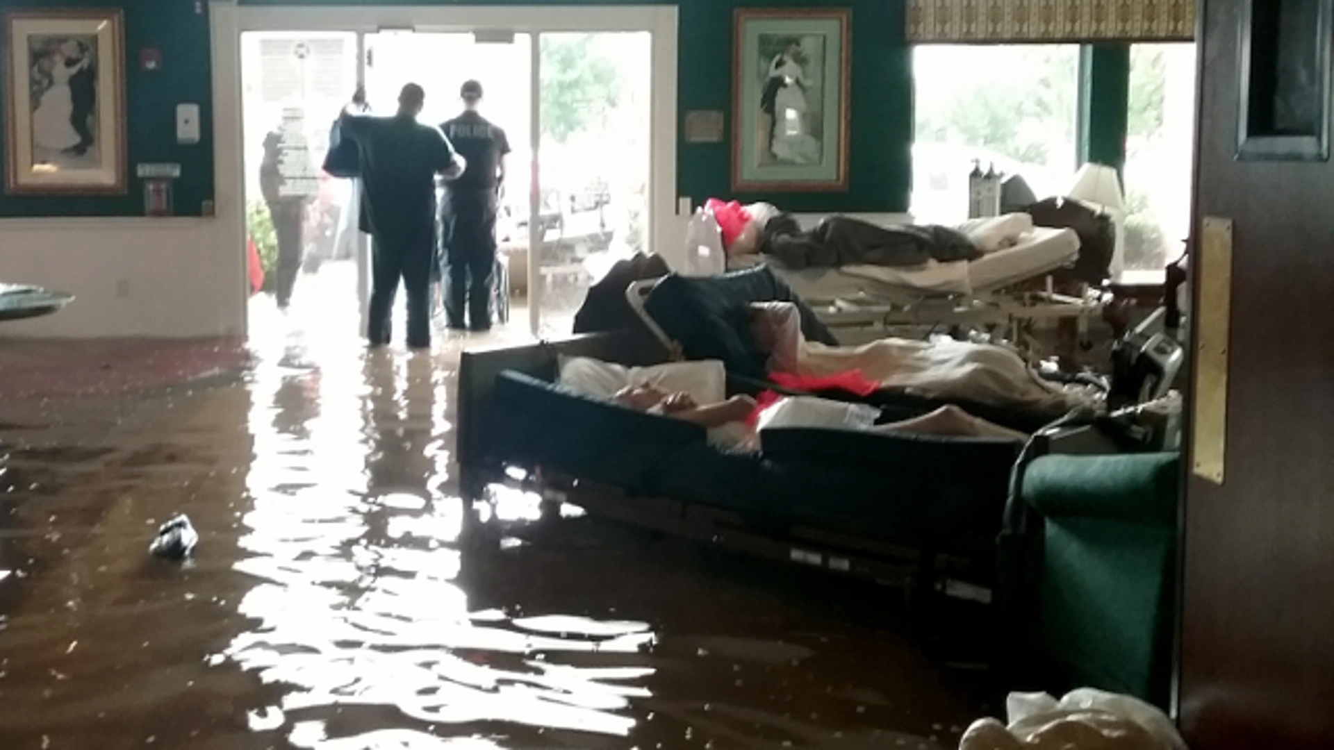 Residents lay on sofas waiting to be evacuated from the Cypress Glen senior care facility in Port Arthur, Texas, which was inundated with water from Hurricane Harvey.