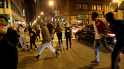 Protesters run after violence broke out on downtown streets in University City, Mo., on September 17, 2017, in the third day of protests following the not guilty verdict of former St. Louis Police officer Jason Stockley in the shooting death of Anthony Lamar Smith.