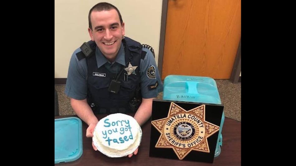 A Facebook post Monday shows Trooper Mitchell Goldman smiling while holding the white frosting cake brought to him by the unidentified deputy who shocked the trooper and a suspect at the same time last week.