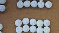Three Lawrence police officers were exposed to the dangerous opioid fentanyl after a Summer Street mother told police her son and a friend were dealing drugs out of her apartment Monday night.