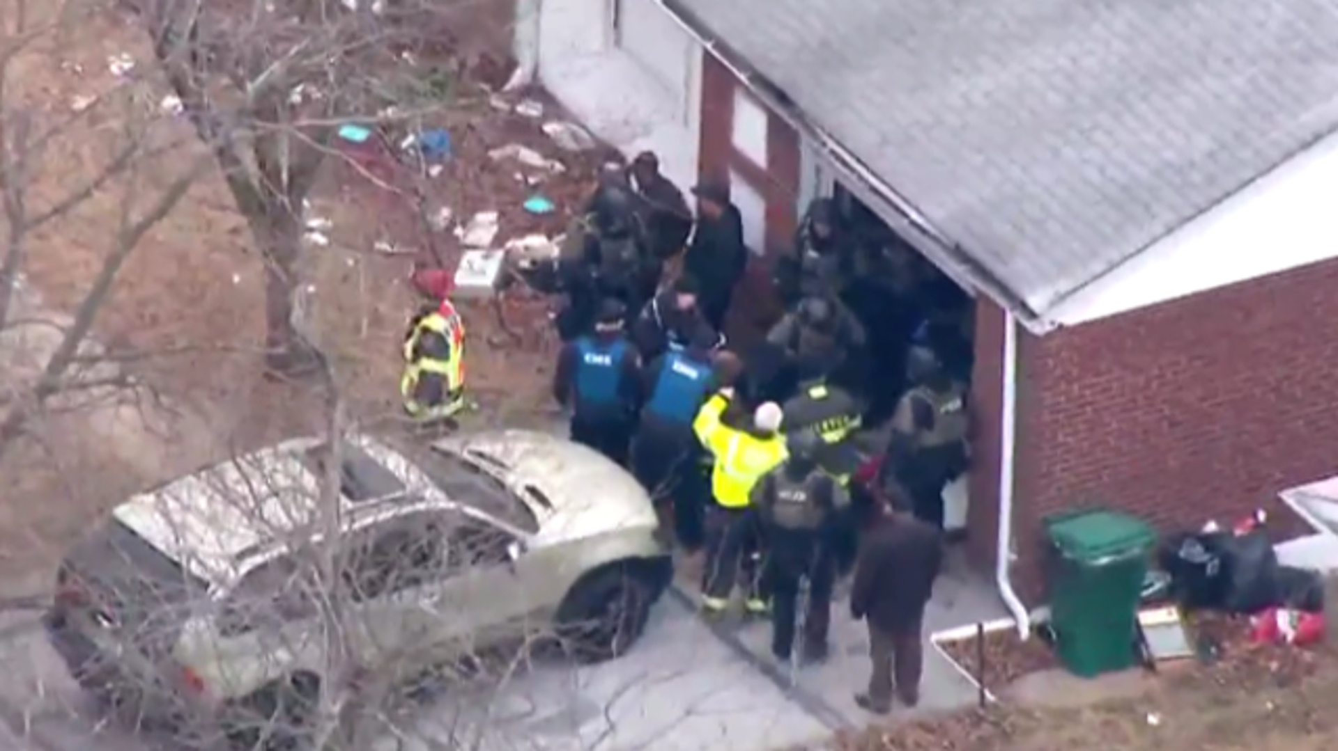 Two police officers were shot in the chest &mdash; but saved by their bulletproof vests &mdash; by a gunman who then barricaded himself in a home in north St. Louis County Thursday morning.
