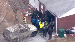 Two police officers were shot in the chest — but saved by their bulletproof vests — by a gunman who then barricaded himself in a home in north St. Louis County Thursday morning.