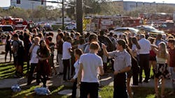 Students are released from a lockdown outside of Stoneman Douglas High School in Parkland, Fla. after reports of an active shooter on Wednesday, Feb. 14, 2018.