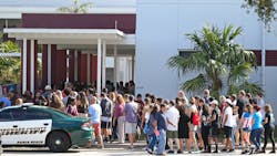 Parents and students walk into Marjory Stoneman Douglas High School on Sunday, February 25, 2018, for an open house as parents and students returned to the school for the first time since 17 people were killed in a mass shooting at the school in Parkland on February 14, 2018.