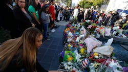 A woman leaves flowersl for fallen Pomona Police Officer Greggory Casillas at the Pomona Police Department Sunday evening in Pomona on March 11, 2018. A woman leaves flowersl for fallen Pomona Police Officer Greggory Casillas at the Pomona Police Department Sunday evening in Pomona on March 11, 2018.