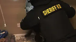Deputies smash through a wall to apprehend Matthew T. Heidbrick on a warrant at his home on March 8.