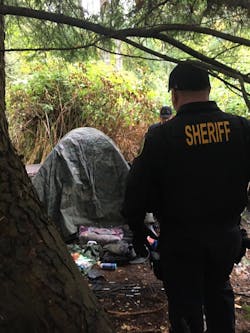 Deputy Bud McCurry (Office of Neighborhoods) visiting a homeless encampment. Going into the community to provide information about treatment is part of SCSO&apos;s strategy.