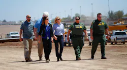 U.S. Department of Homeland Security Secretary Kirstjen M. Nielsen, middle, stops for a brief visit along the U.S.-Mexico border, where construction for the bollard fence is currently underway along the border in Calexico on Wednesday, April 18, 2018.