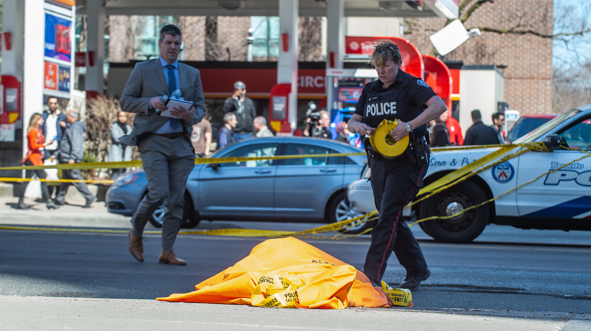 A covered body is seen in Toronto after a van mounted a sidewalk crashing into a number of pedestrians on Monday, April 23, 2018.