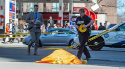 A covered body is seen in Toronto after a van mounted a sidewalk crashing into a number of pedestrians on Monday, April 23, 2018.