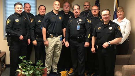 Seventeen weeks after being wounded in a shooting that claimed the life of one of his comrades, Douglas County Sheriff's Deputy Jeff Pelle, fourth from the left, is back on the job.