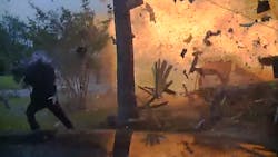 Hurst Police Officer Travis Hiser is shown being blown back, but he recovers and assists police Cpl. Ryan Tooker in getting a couple out of the home. Hurst Police Officer Travis Hiser is shown being blown back, but he recovers and assists police Cpl. Ryan Tooker in getting a couple out of the home.