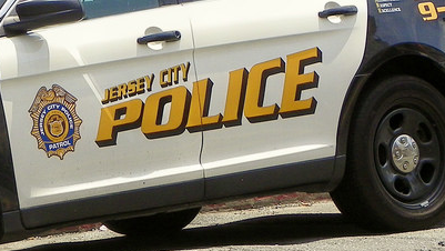 A Jersey City police officer hit in the head was transported to a local hospital to be treated for a brain hematoma, a lip injury and a swollen right hand.
