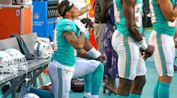 Miami Dolphins receivers Kenny Stills and Albert Wilson kneel during the national anthem as they prepare to play the Tampa Bay Buccaneers at Hard Rock Stadium in Miami Gardens, Fla., on Thursday, Aug. 9, 2018.