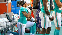 Miami Dolphins receivers Kenny Stills and Albert Wilson kneel during the national anthem as they prepare to play the Tampa Bay Buccaneers at Hard Rock Stadium in Miami Gardens, Fla., on Thursday, Aug. 9, 2018.