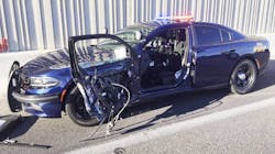 The Nevada Highway Patrol says this car was pulled over Monday, Aug. 6, 2018, on a traffic stop when a passing car hit the door as a trooper was getting out. The Nevada Highway Patrol says this car was pulled over Monday, Aug. 6, 2018, on a traffic stop when a passing car hit the door as a trooper was getting out.