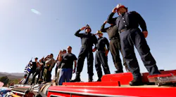 Firefighters salute the procession as the hearse carrying the casket of Ventura County Sheriff Sgt. Ron Helus, who was killed yesterday in the Thousand Oaks mass shooting, as it heads north on the 101 Freeway headed to Ventura.
