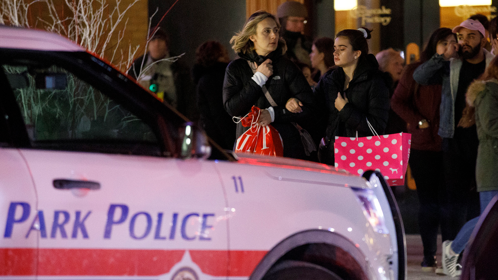 People leave the scene where a gunman shot and injured a man near the food court inside the Orland Square Mall Monday Jan. 21, 2019, in Orland Park, Ill.