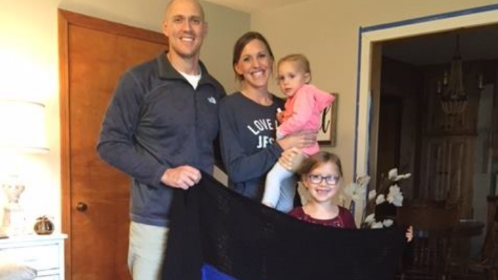 Wounded Oklahoma Highway Patrol Trooper Austin Ellis is seen in a photo released by the Oklahoma Highway Patrol with his wife, Kristen, and daughters Brooklyn and Jovi holding the afgan.