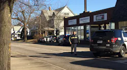 A Lafayette police officer was shot in the back by a colleague after a dog charged at the officers during an investigation Tuesday morning.