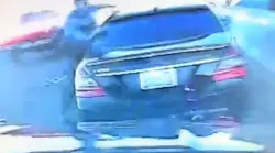 A Nevada Highway Patrol trooper was injured after he was hit by debris when a driver struck his cruiser as he stood outside of it Saturday morning.