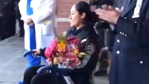 NYPD Officer Vanessa Rodriguez, who was injured as the carjacking and robbery suspects attempted to make a getaway Sunday, left Jacobi Medical Center as officers lined the sidewalk and bagpipe music played.