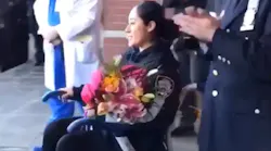 NYPD Officer Vanessa Rodriguez, who was injured as the carjacking and robbery suspects attempted to make a getaway Sunday, left Jacobi Medical Center as officers lined the sidewalk and bagpipe music played.