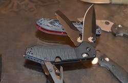 The Benchmade Outlast has 3 blades; an CPM-S30V drop point, a CPM-3V serrated blade with a squared off tip and 02 wrench, a 440 rescue hook, and a carbide tip glass breaker. The other blade that caught my eye was the one on which the Outlast is propped. This is the Freek in Deadpool colors.