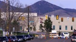 An officer stands guard outside Columbine High School in Littleton, Colorado, one day after the massacre at the suburban Denver school in 1999. Fourteen students and one teacher were killed at the school when two teenage gunmen opened fire on their schoolmates. An officer stands guard outside Columbine High School in Littleton, Colorado, one day after the massacre at the suburban Denver school in 1999. Fourteen students and one teacher were killed at the school when two teenage gunmen opened fire on their schoolmates.