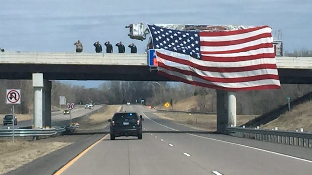 Authorities salute a procession for Minnesota Department of Natural Resources officer Eugene Wynn Jr., 43, on Sunday, April 21, 2019.