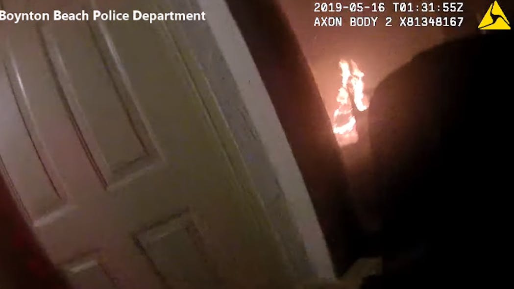 Newly released body camera video shows two Boynton Beach police officers rescue four people from a burning home Wednesday night.