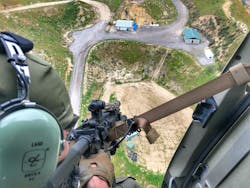 A SWAT operator deploying a short barreled rifle (SBR) with red dot optic utilizing an aerial platform sling in a rapid ascent training iteration. A SWAT operator deploying a short barreled rifle (SBR) with red dot optic utilizing an aerial platform sling in a rapid ascent training iteration.