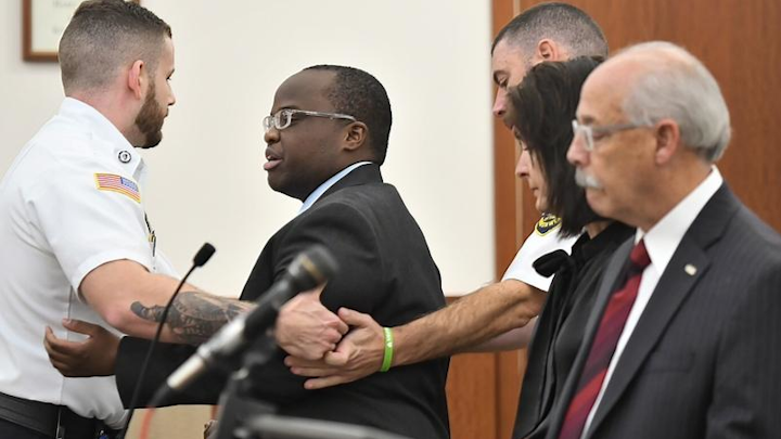 Defendant David K. Njuguna, the driver charged in the Massachusetts Turnpike death of Trooper Thomas L. Clardy, was hurriedly removed from the courtroom after an outburst Tuesday morning.