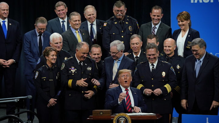 President Donald Trump signs an executive order establishing a new executive 'Commission on Law Enforcement ' and the 'Administration of Justice ' at the International Association of Chiefs of Police Annual Conference at McCormick Place on Oct. 28, 2019.