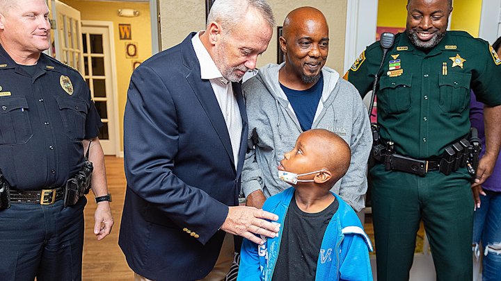 t. Johns County Sheriff David Shoar talks to Arcolia Gilliard Jr., 7, in the clubhouse of his apartment complex in St. Augustine on Friday. Arcolia, who is recovering from cancer, was surprised by local law enforcement officers with a weeklong trip to Disney World. Standing with Gilliard are St. Augustine Beach Police Chief Robert Hardwick, his father Arcolia Gilliard Sr., and deputy Sgt. Napolian Staggers who help organize the surprise.