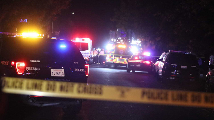 Police and emergency vehicles are on the scene Sunday, Nov. 17, 2019, of a massing shooting in southeast Fresno, Calif.