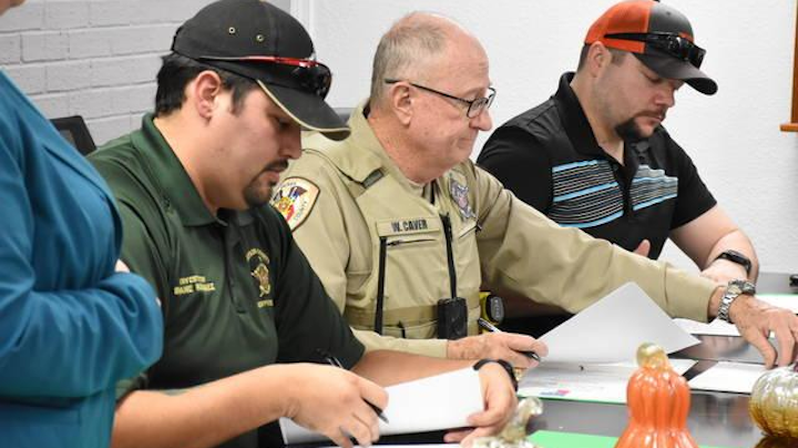 Grayson County Sheriff's deputies and other law enforcement officers sign off on training paperwork Tuesday for the Mental Health Peace Officer Program. The program aims to equip local police with skills and knowledge helpful in the event of mental-health crisis calls.