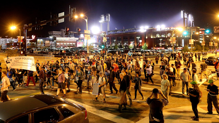 A group of about 200 protesters march along 8th Street near Busch Stadium on Friday, Sept. 29, 2017, during demonstrations outside of Busch Stadium. Demonstrators marched to the stadium as a Cardinals game against Milwaukee was in progress.