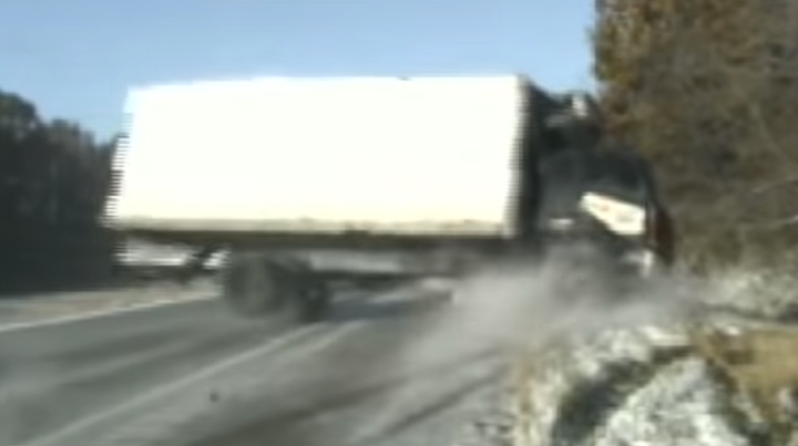 Two Illinois State Police officers and a woman changing a tire were nearly hit when a truck slid off the highway. The incident was captured on a dash camera.
