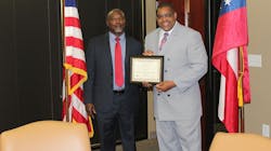 Narcotics Investigator Cecil Ridley, left, is seen being honored for his service with the Richmond County Sheriff&apos;s Office.