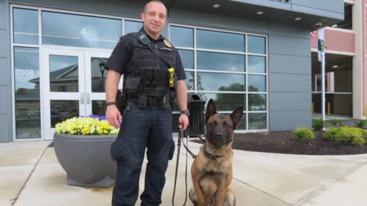 Officer Jarred Koopman, left, with K-9 Harlej