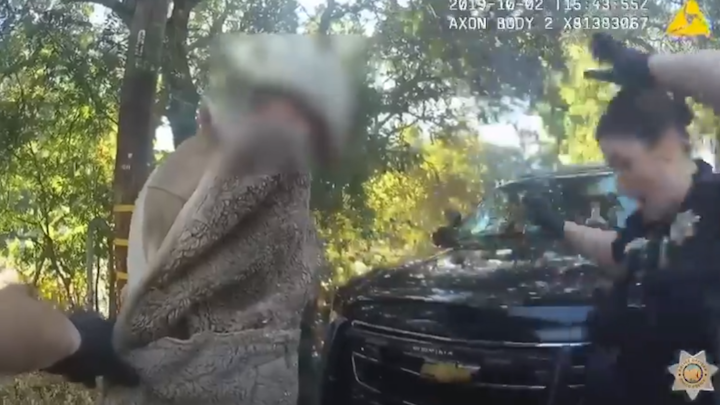 A Northern California police officer gets the shock of her life when a lizard leaps from the coat pockets of a man during a routine search, a body camera video shows.