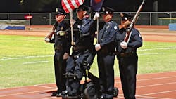 Peoria Police Officer William Weigt, who was paralyzed in the line of duty 14 years ago, was able to stand once again for the national anthem thanks to the help of a special wheelchair.