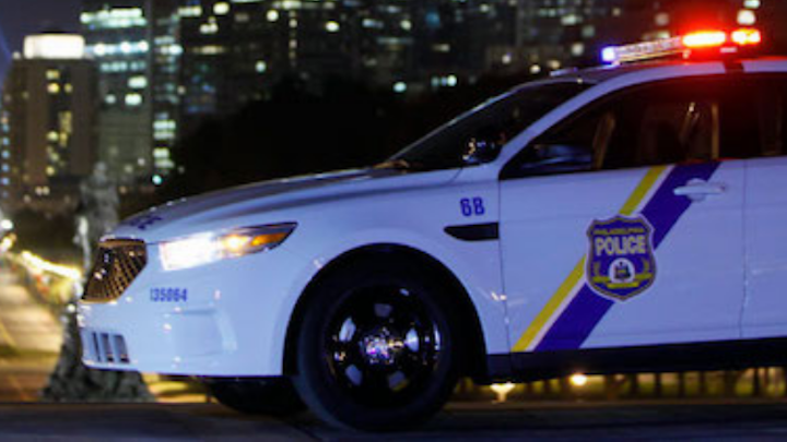 Police are looking for the shooter who fired at an off-duty police officer when he got out of his car to stop an assault on a man outside a West Philadelphia bar, authorities said.