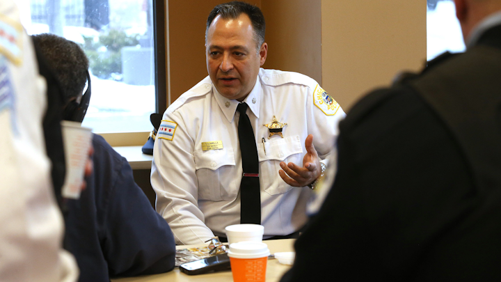 Chicago Police Commander Anthony Escamilla talks with officers and guests at the Dunkin Donuts in Chicago, Thursday, Jan. 17, 2019.