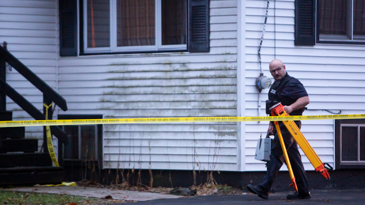 An officer walks back to the crime lab near a house on the 6300 block of Proctor Avenue in Comstock Township, Michigan on Monday, December 2, 2019.