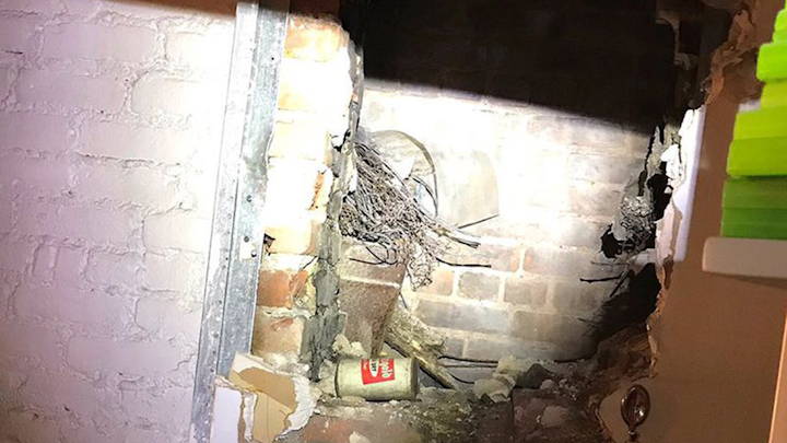 Rescuers had to cut a hole through a wall early on December 29, 2019, to rescue a 36-year-old woman after a 911 caller heard her desperate cries for help. ()
